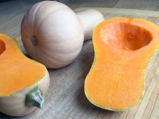Pale tan and deep orange Butterbush winter squash side by side